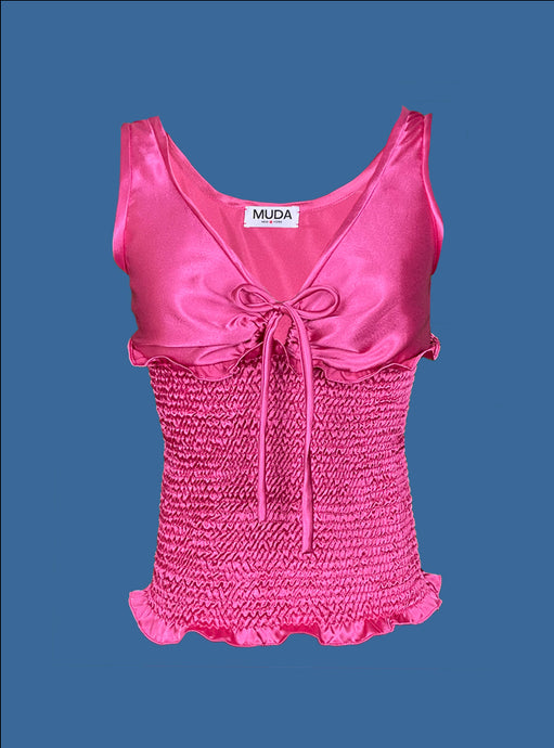 Hot Pink Top Front. Shirred body. Sleeveless. Tie straps in middle of bust. Ruffles at beginning and end of shirred body.